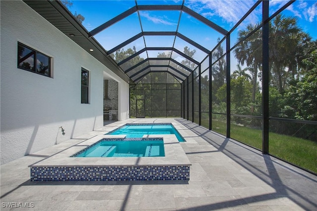 view of swimming pool featuring a lanai, a patio area, and an in ground hot tub