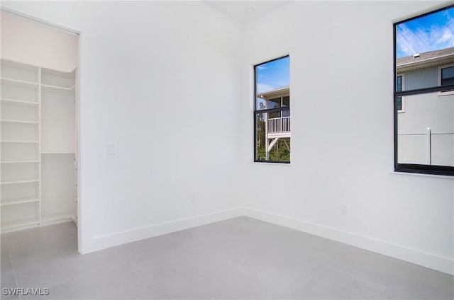 unfurnished bedroom with a closet and concrete floors