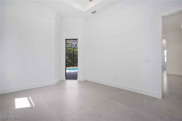 spare room featuring a towering ceiling