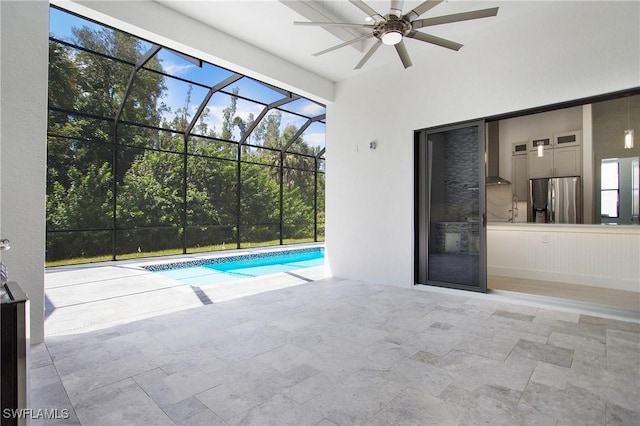 view of pool with a lanai, a patio area, and ceiling fan