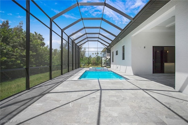 view of swimming pool featuring an in ground hot tub, a patio, and a lanai