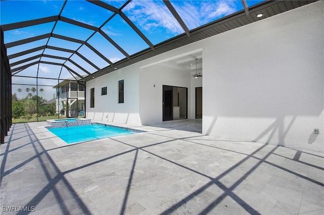 view of swimming pool featuring ceiling fan, a patio area, a lanai, and an in ground hot tub