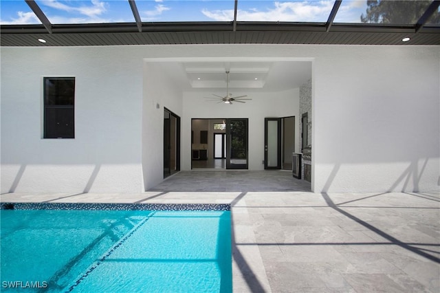 view of pool featuring ceiling fan, a patio area, and glass enclosure