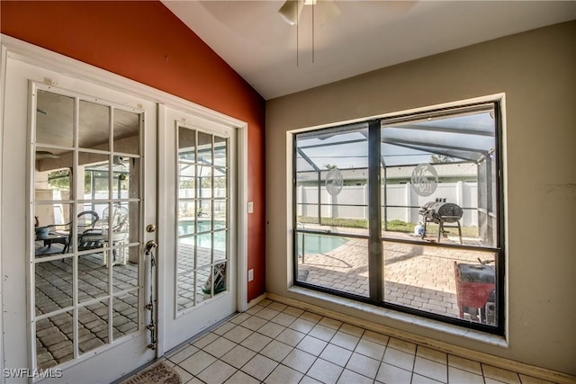 entryway featuring lofted ceiling, light tile patterned floors, and french doors