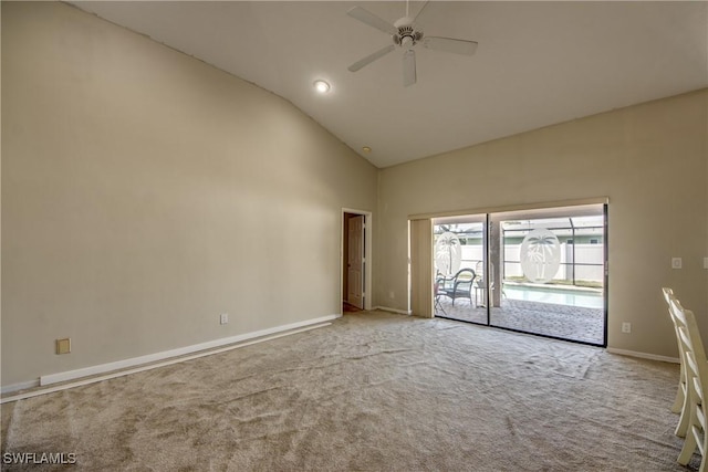 carpeted spare room featuring ceiling fan and high vaulted ceiling