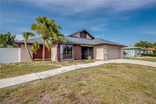 view of front of property featuring a front lawn and a garage