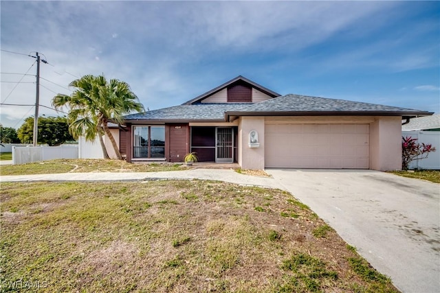 view of front of property featuring a garage and a front lawn