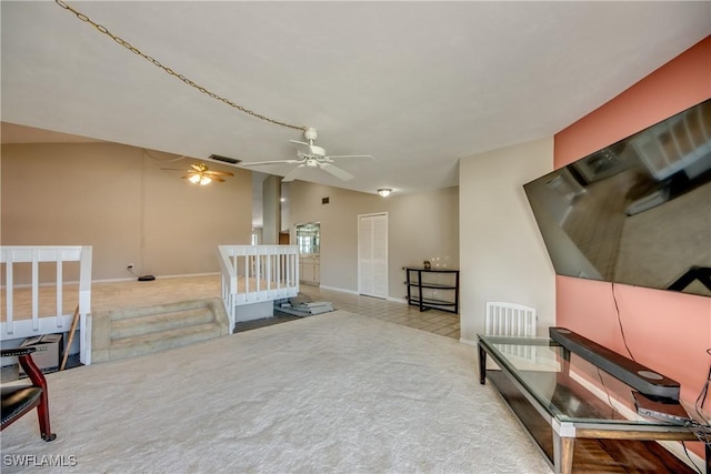 sitting room with light colored carpet, vaulted ceiling, and ceiling fan