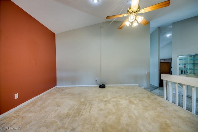 carpeted empty room featuring vaulted ceiling and ceiling fan