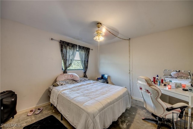 bedroom with ceiling fan and concrete floors