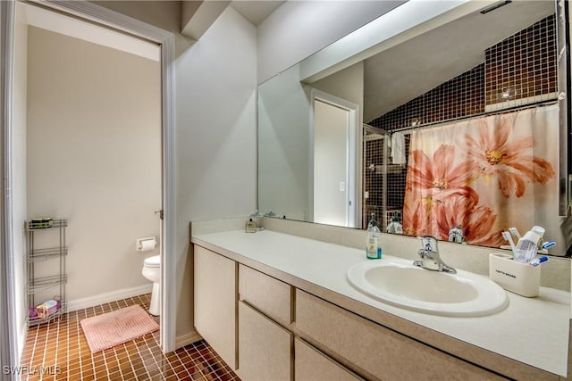 bathroom featuring tile patterned floors, vanity, curtained shower, and toilet