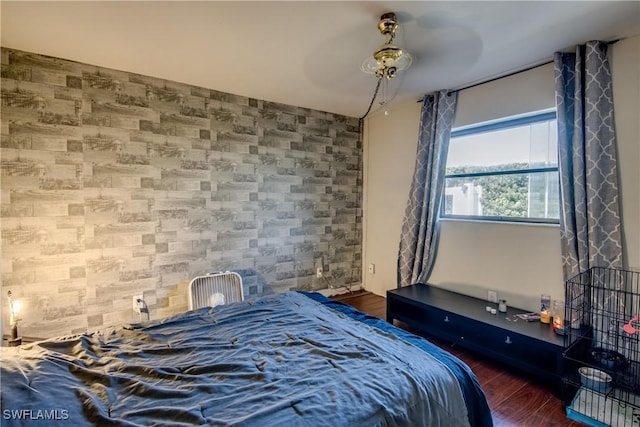 bedroom with ceiling fan and dark wood-type flooring