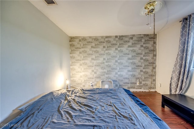 bedroom featuring ceiling fan and dark hardwood / wood-style floors