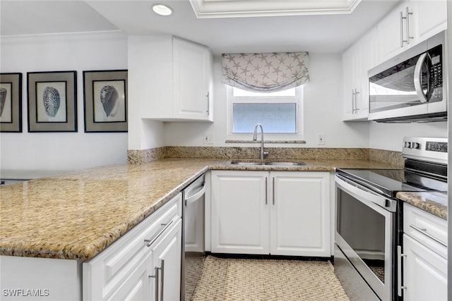 kitchen featuring white cabinetry, sink, ornamental molding, stainless steel appliances, and light stone countertops