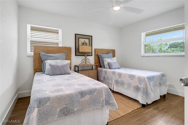 bedroom with dark wood-type flooring and ceiling fan