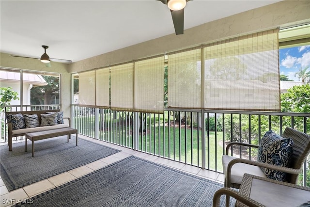 sunroom / solarium featuring ceiling fan