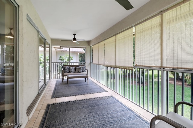 unfurnished sunroom featuring ceiling fan