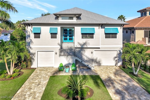 view of front of home featuring a garage and a front lawn