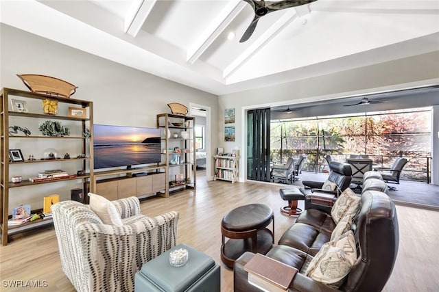 living room with ceiling fan, light hardwood / wood-style flooring, and lofted ceiling with beams