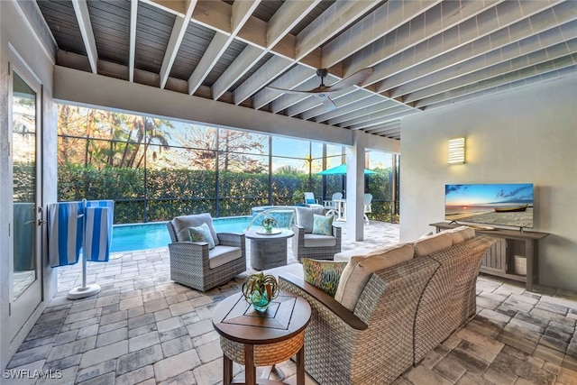 view of patio / terrace featuring a lanai, an outdoor hangout area, ceiling fan, and pool water feature