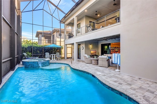 view of swimming pool with an in ground hot tub, a lanai, an outdoor hangout area, and a patio