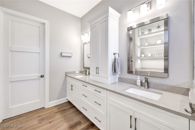 bathroom with hardwood / wood-style floors and vanity