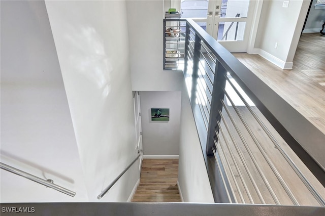 stairway with hardwood / wood-style floors