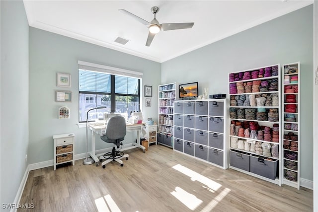 home office featuring ceiling fan, ornamental molding, and light hardwood / wood-style flooring