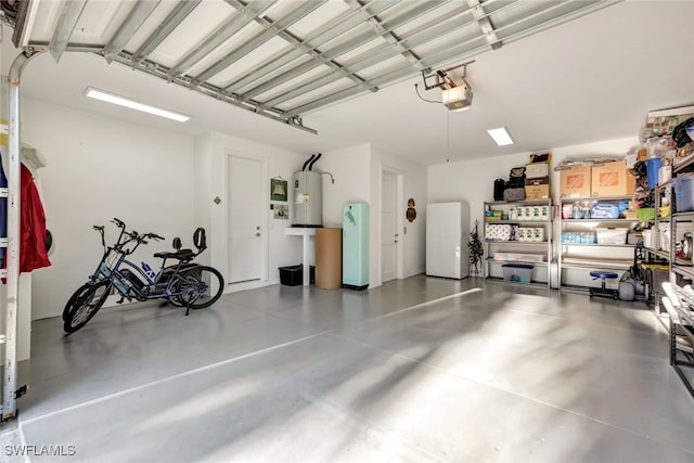 garage featuring a garage door opener and electric water heater