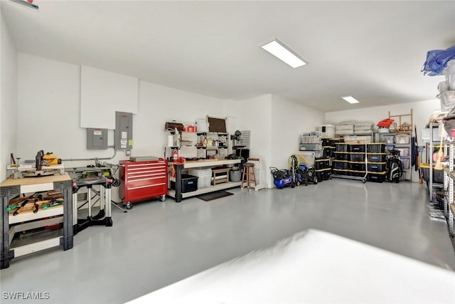 garage featuring electric panel and a workshop area