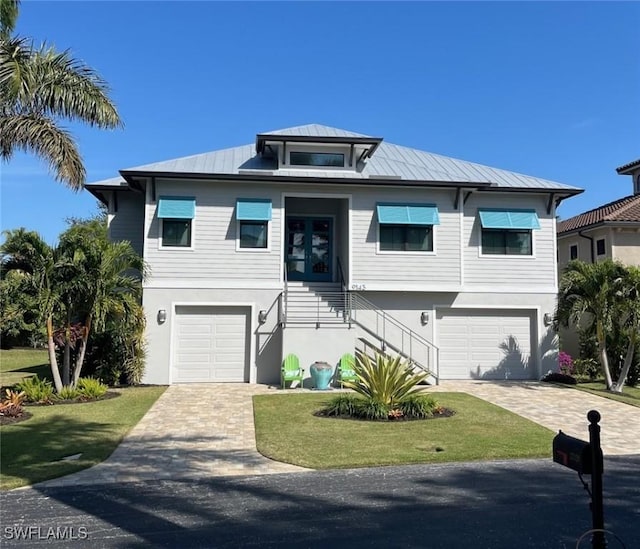 view of front of house with a front yard and a garage