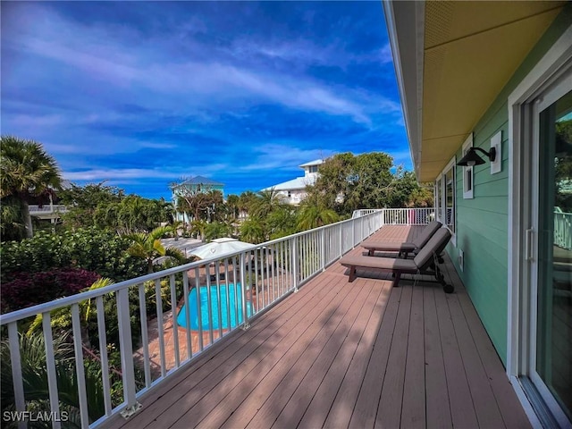 wooden terrace with a swimming pool