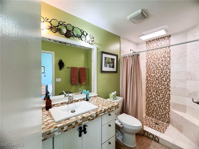 bathroom with tile patterned flooring, toilet, walk in shower, and sink