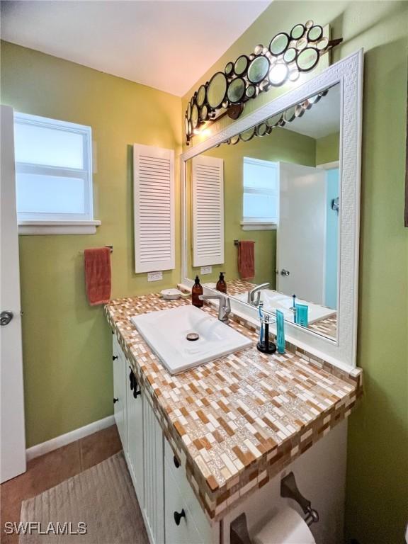 bathroom with tile patterned flooring and vanity