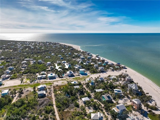 birds eye view of property featuring a beach view and a water view