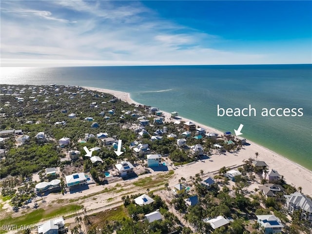 bird's eye view with a water view and a view of the beach