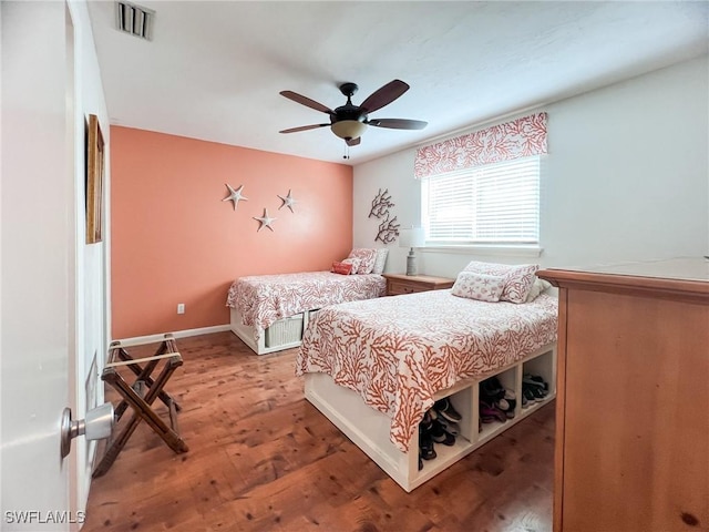 bedroom featuring wood-type flooring and ceiling fan