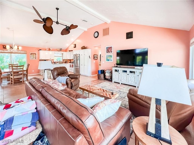 living room featuring ceiling fan with notable chandelier, lofted ceiling with beams, and light tile patterned floors