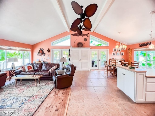 living room with ceiling fan with notable chandelier, french doors, lofted ceiling with beams, and light tile patterned flooring