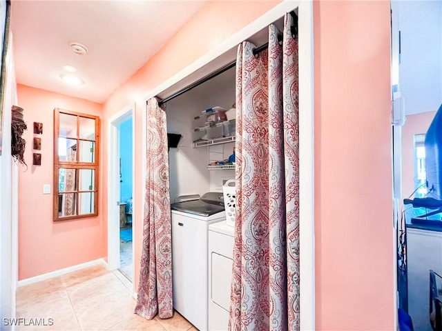 washroom with washing machine and dryer and light tile patterned floors