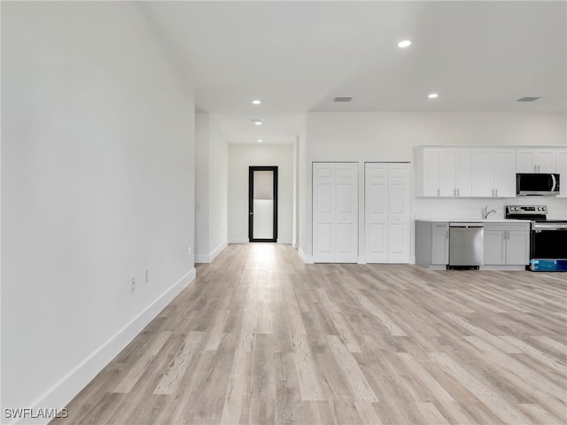 unfurnished living room with light hardwood / wood-style flooring