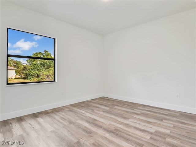 spare room with light hardwood / wood-style flooring