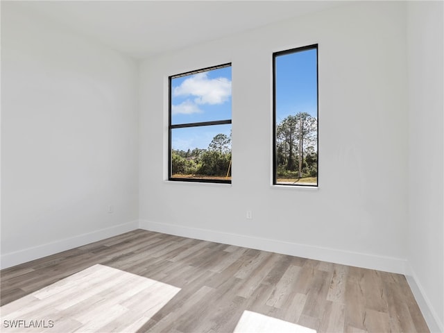 empty room with light hardwood / wood-style flooring