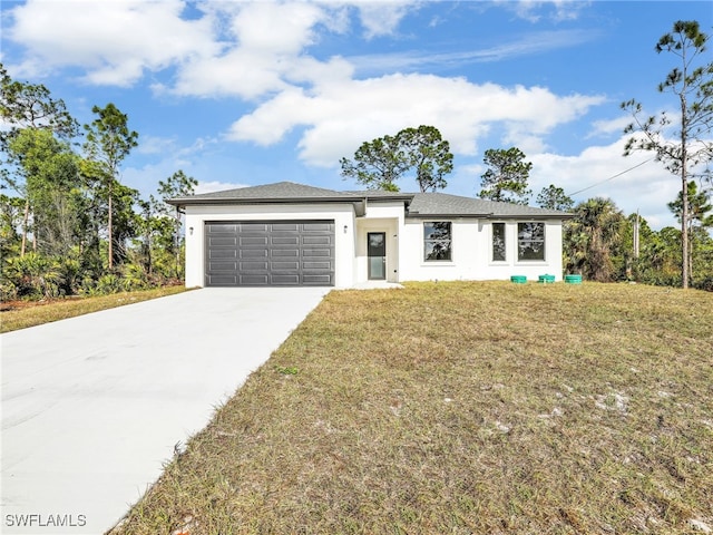 view of front of property featuring a front yard and a garage