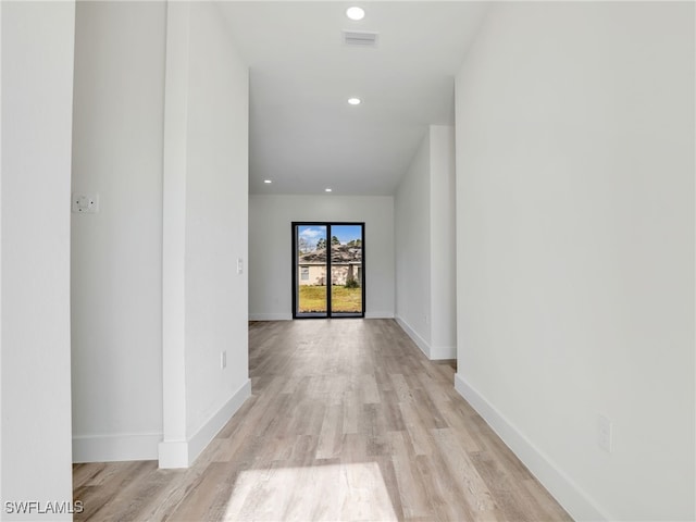 corridor with light hardwood / wood-style flooring