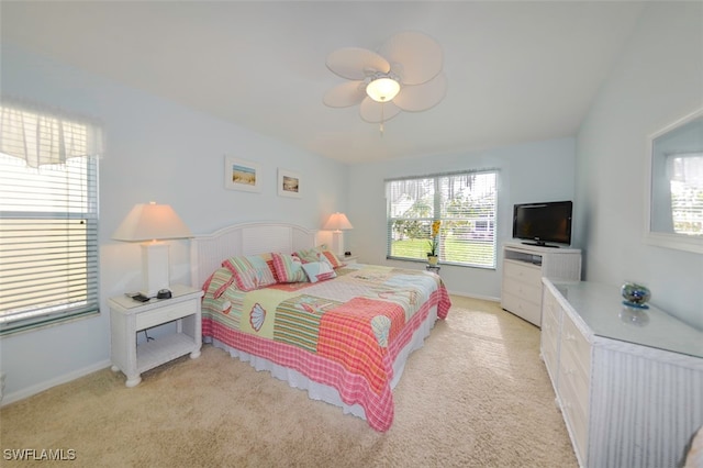 bedroom with ceiling fan and light carpet