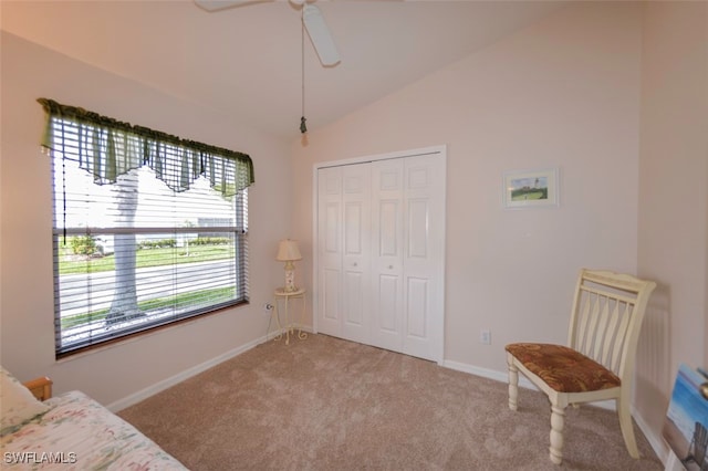 sitting room with carpet, vaulted ceiling, and ceiling fan