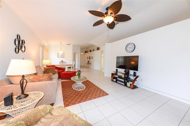 living room featuring ceiling fan, light tile patterned flooring, and lofted ceiling