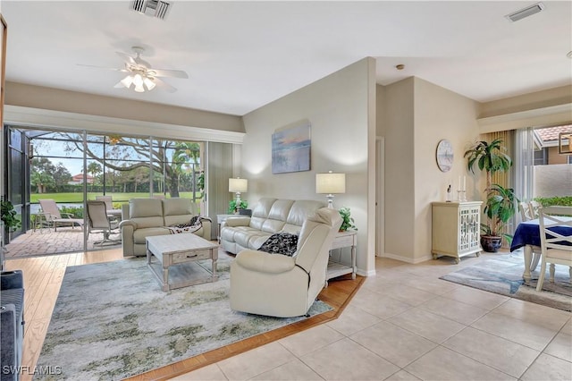 tiled living room featuring ceiling fan