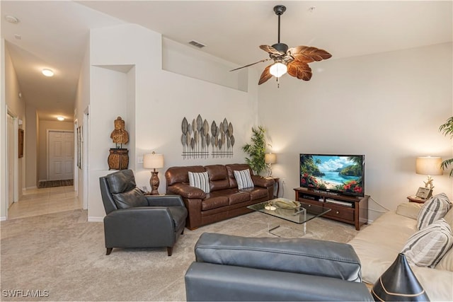 living room with light carpet, ceiling fan, and visible vents